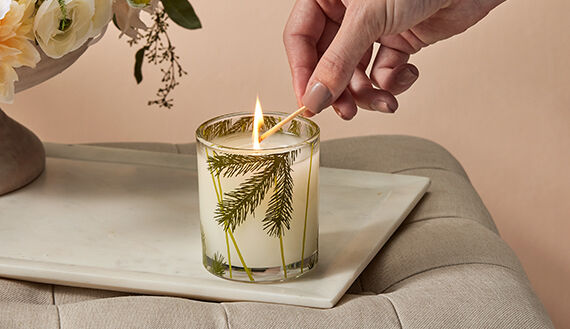 Thymes Candles featuring Frasier Fir being lit by a match